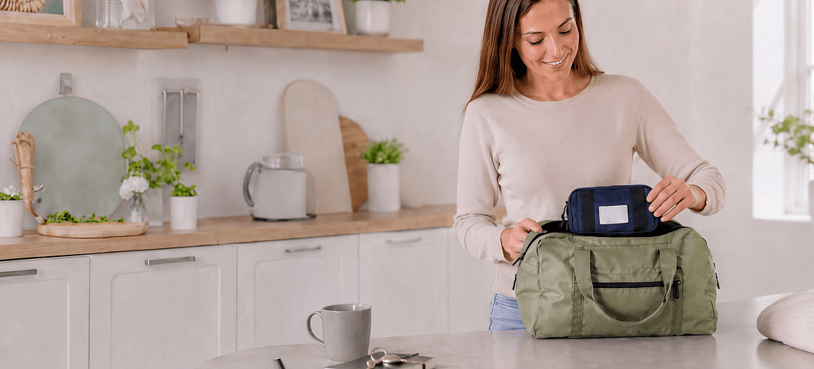 A parent packing the Kiri pouch into a bag in a kitchen